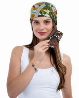 A woman holding a slim passport holder featuring a printed monarch butterfly wing pattern.