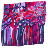 A square silk scarf featuring a vibrant, multicolored abstract floral and geometric print.