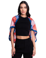 Woman wearing a black outfit with a colorful floral silk scarf