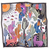 A square silk scarf featuring a vibrant desert inspired pattern.