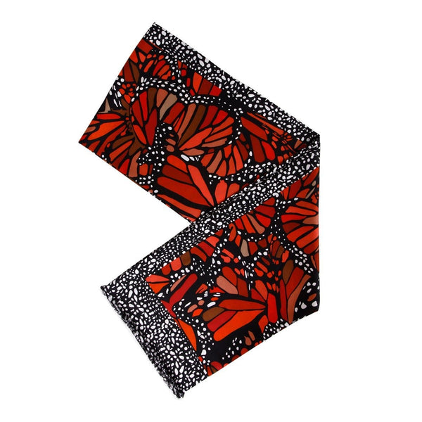 Folded scarve with red butterfly pattern on a white background
