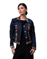 Woman wearing a denim jacket with monarch butterfly pattern