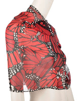 Red butterfly patterned shawl on a mannequin against a white background
